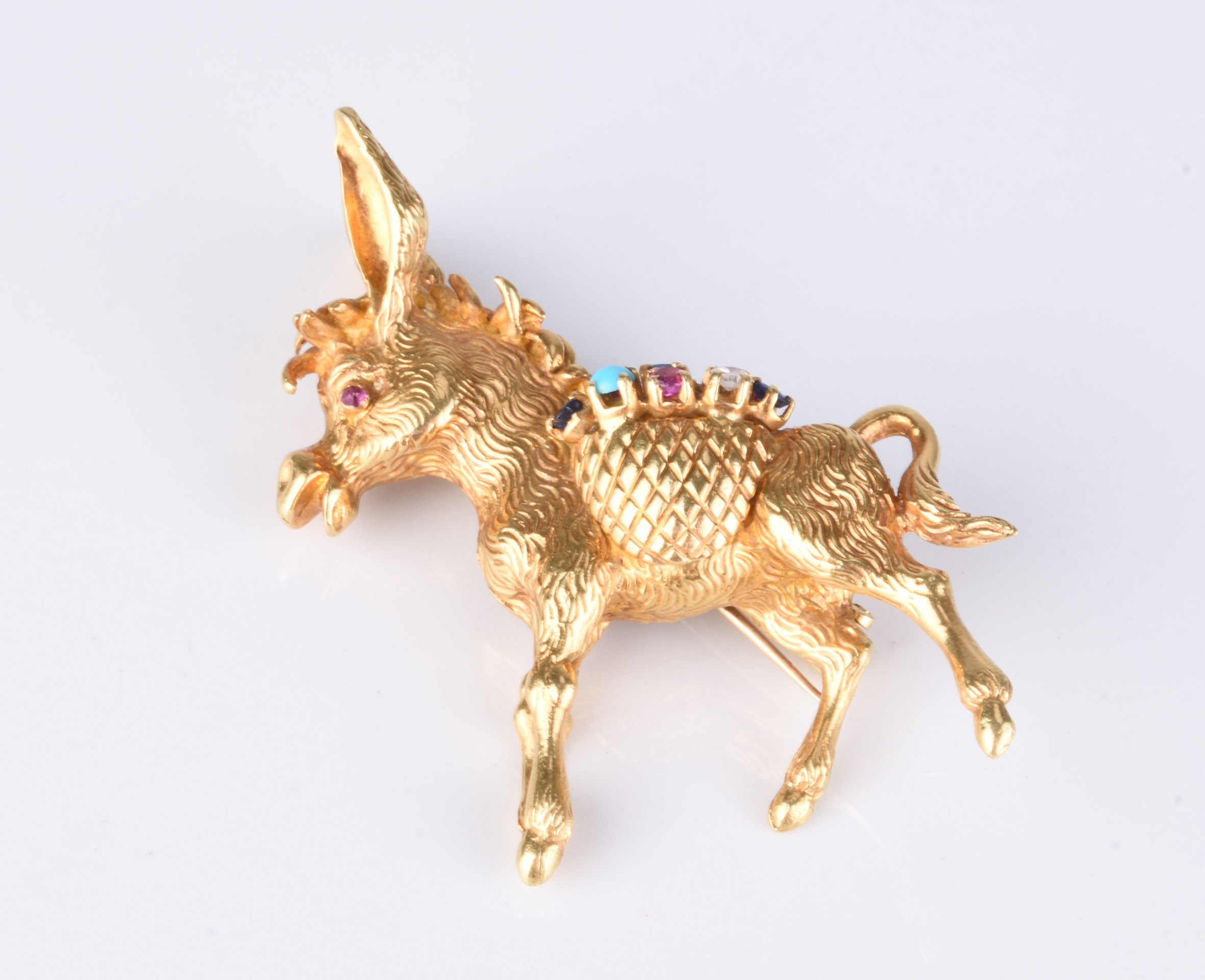 An 18ct gold, gem set novelty donkey brooch valued up to £1,200. Halls Fine Art Christmas Auction